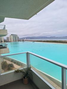 a balcony with a large blue swimming pool at Alojamiento en la Serena - Chile in La Serena