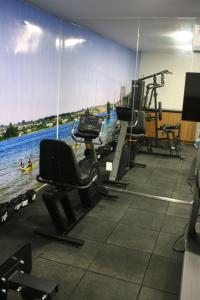 a gym with a view of the water at Noroeste Easy by CentoEdez in Brasília