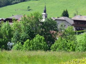 a building in a field with trees and a church at Appartement Bernex, 2 pièces, 6 personnes - FR-1-498-31 in Bernex