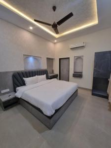 a bedroom with a large bed with a ceiling at Green Villa in Udaipur