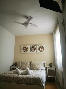 a bedroom with a bed with a ceiling fan at ZUBICALM in La Zubia
