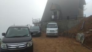 three cars parked on a dirt road next to a building at Ayu Bliss Elamulla, Mandaramnuwara in Mandaran Newara