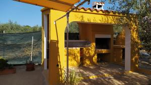 a yellow house with a yellow roof and a patio at Casa Eli in L'Ampolla +31 photos