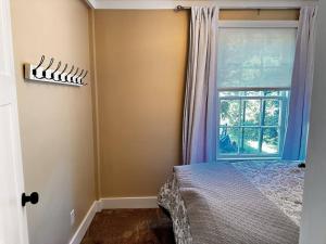 a bedroom with a bed next to a window at Fireside Cottage in Jacksonville