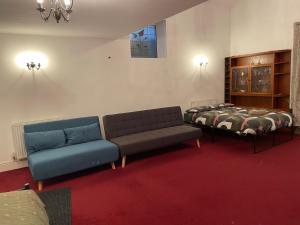 a room with two beds and a couch and a bed at Lovely Calm Independent Home in Belvedere