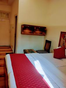 a hotel room with a bed and a couch at Bhagyashree Guest House in Varanasi