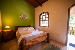 a bedroom with a bed and a window at Casa da Praia in Paraty +45 photos