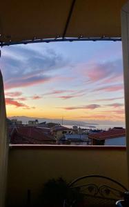 a view of a sunset from a window at Hotel Scilla in Scilla
