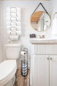 a white bathroom with a toilet and a sink at 7 Le Soleil Retro Tiny House, Boat Parking, Mins to Lake Guntersville, City Harbor in Guntersville