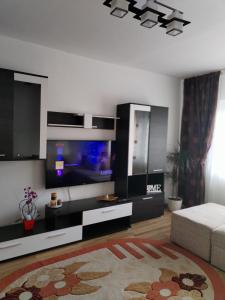 a living room with a large tv and a couch at Noua Apartment in Braşov
