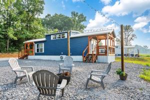 a tiny house with chairs and a cabin at 8 All Decked Out, Luxury Tiny House, Boat Parking Mins to Lake Guntersville, Downtown in Guntersville