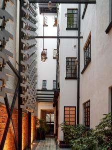 an internal courtyard of a building with a spiral staircase at Casa Decu in Mexico City
