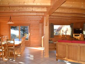 a dining room of a log cabin with a table and chairs at Chalet Le Grand-Bornand, 7 pièces, 14 personnes - FR-1-467-64 in Le Grand-Bornand