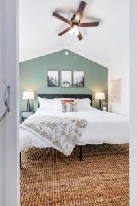 a bedroom with a large bed with a ceiling fan at Luxury Tiny House Mins to Lake, Downtown Guntersville Boat Parking in Guntersville