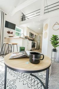 a coffee cup sitting on a table in a living room at Luxury Tiny House Mins to Lake, Downtown Guntersville Boat Parking in Guntersville +38 photos
