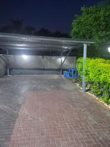 a parking lot at night with a parking garage at The wood Guest house in Pretoria