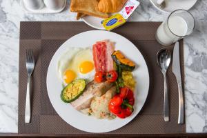 a plate of breakfast food with eggs meat and vegetables at SR Hotel Magok in Seoul