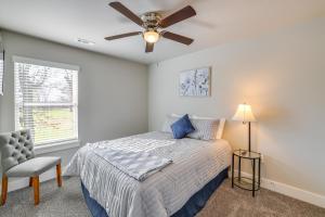 a bedroom with a bed and a ceiling fan at Modern Springdale Home 13 Mi to Fayetteville! in Springdale