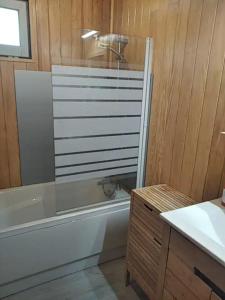 a bathroom with a shower and a tub and a sink at Grand Chalet au pays du Mont Blanc in Vallorcine