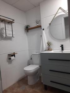 a white bathroom with a toilet and a sink at Apartamento céntrico Benalmádena pueblo in Benalmádena