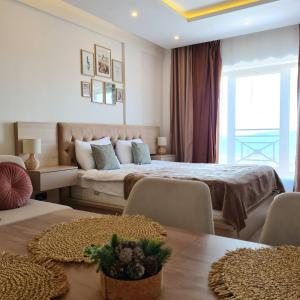 a hotel room with two beds and a couch at Mountain Side Kopaonik in Kopaonik