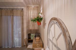 a dining room with a table and a plant on the wall at LA CASA DI ZOE in Manfredonia