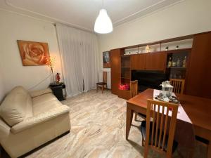 a living room with a couch and a dining room table at La casa di Stefania vista mare in Francavilla al Mare