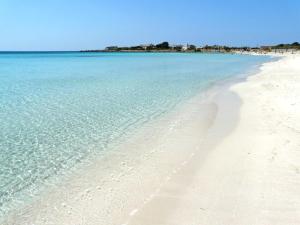 una spiaggia con acqua cristallina e sabbia bianca di Casa degli Angeli a Porto Cesareo