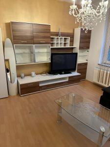 a living room with a tv and a glass table at Privatunterkunft, Ferienwohnung, Monteurswohnung in Bottrop