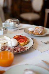 a table with two plates of food on it at Palazzo Zacà in Gallipoli
