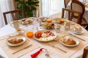 a table with plates of breakfast food on it at Palazzo Zacà in Gallipoli