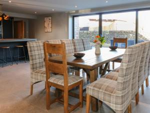 a dining room with a wooden table and chairs at Farley Meadow View in Matlock