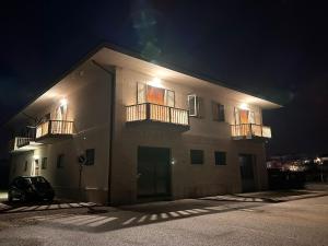 a building with two balconies on the side of it at night at La casa di Stefania vista mare in Francavilla al Mare