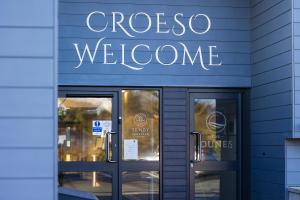 a store front with a sign that reads crossoco welcome at The Dunes in Tenby