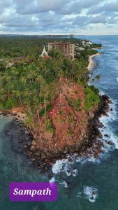 an island in the ocean next to the water at Minara Guest House in Mirissa