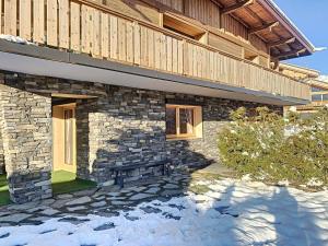 a stone building with a bench in front of it at Chalet Combloux, 5 pièces, 8 personnes - FR-1-560-32 in Combloux