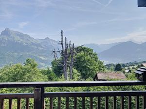 a balcony with a view of a mountain range at Studio confortable au centre de Combloux avec parking et accès ski bus - FR-1-560-35 in Combloux
