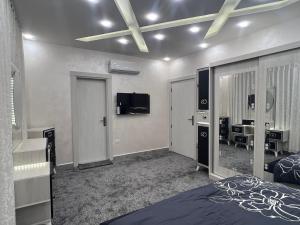 a bedroom with a bed and a dressing room at Asia Hotel Apartments in Irbid
