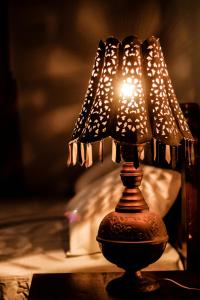 a lit lamp sitting on top of a table at Muduna Walawwa Resort in Kandy