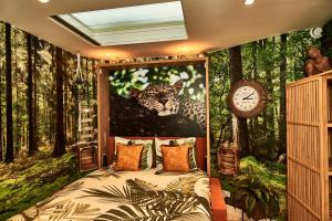 a bedroom with a painting of a leopard in the forest at Heaven in East B&B in Amsterdam