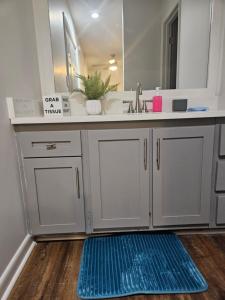 a bathroom with a sink and a mirror at Lofty Haven, your home away from home! in Huntsville