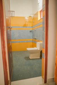 a bathroom with a toilet and a sink at Shimano Square in Varkala