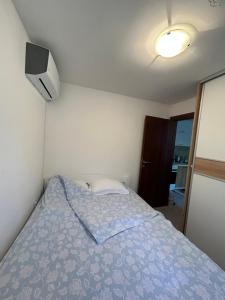 a bedroom with a bed with a blue comforter at Midpoint in Kotor