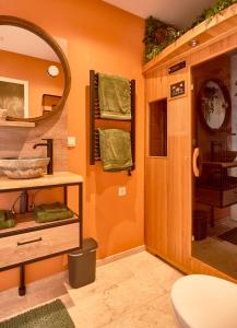 a bathroom with a mirror and a sink and a toilet at Heaven in East B&B in Amsterdam