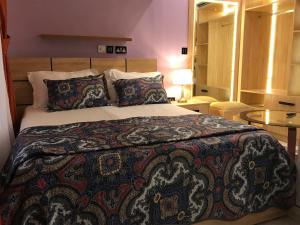 a bedroom with a bed with a colorful blanket at S.K PLAZA in East Legon