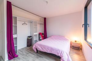 1 dormitorio con cama rosa y ventana en Maison familiale à Trégastel - proche des plages, en Trégastel