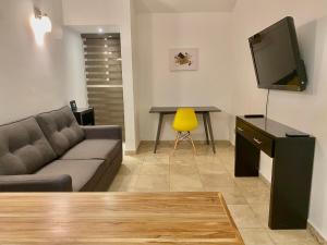 ein Wohnzimmer mit einem Sofa und einem Tisch mit einem TV in der Unterkunft Hermosa Casa con Alberca MC2 - 3 habitaciones max 9 huéspedes in Los Sauces
