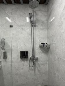 a shower with a glass door in a bathroom at Mir Luxe Plaza in Tashkent