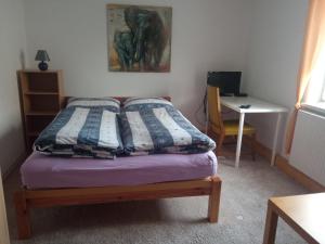 a bed with two pillows on it in a room at Ferienhaus am Geiseltalsee in Braunsbedra