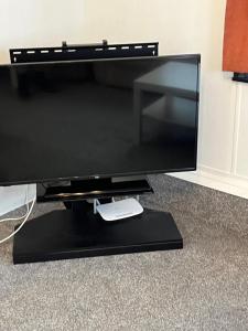 a flat screen tv sitting on a black stand at CW27 St Osyth Holiday Park with disability Ramp in Saint Osyth